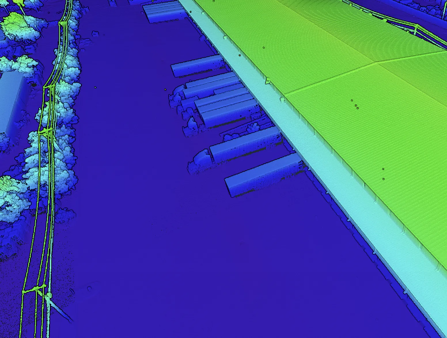 Elevation-colorized detail of the loading dock face: trailers and dock canopies isolated in blue against the green roof plane.