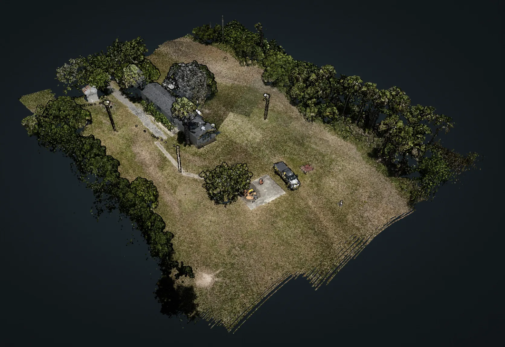The same capture rendered in true color: buildings, drive, tree cover, and parked vehicles on the site.